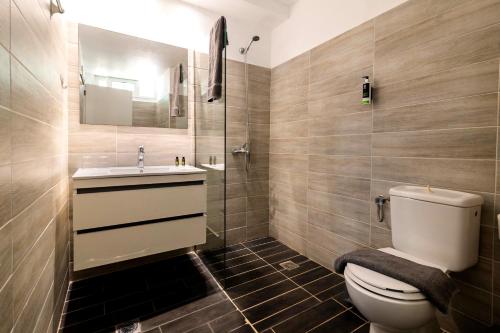a bathroom with a toilet and a sink and a shower at Lefka Hotel & Apartments in Rhodes Town