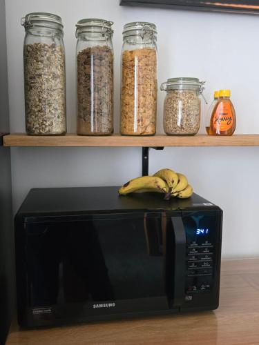 a black microwave with some bananas on top of it at Victorian Renovation Room 5 in Liverpool