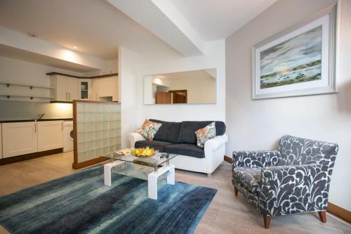 a living room with a couch and a table at Parnell Boulevard Apartments in Dublin