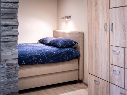 a bedroom with a bed with blue comforter at Maramaa Backyard Bliss in Viljandi