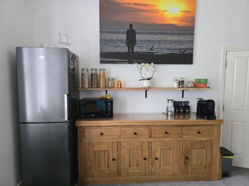 a kitchen with a refrigerator and a wooden counter at Victorian Renovation Room 6 in Liverpool