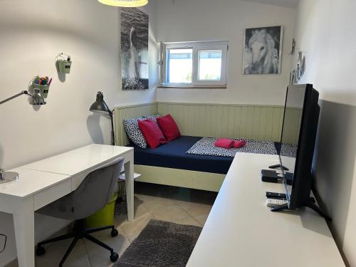 a room with a bed with a desk and a computer at Apartman Barby Jadranovo in Jadranovo