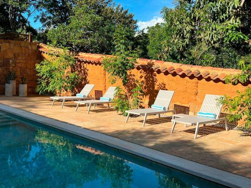 a group of chairs sitting next to a swimming pool at Terrazul Barichara in Barichara