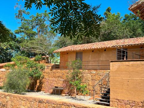 a house with a stone wall and stairs to it at Terrazul Barichara in Barichara