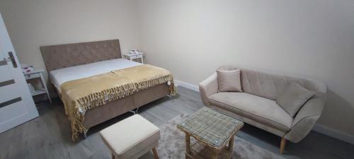 a living room with a bed and a couch at Apartmán pri hrade in Levice