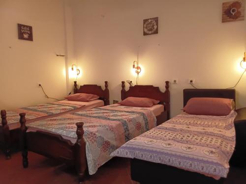 two beds in a room with lights on the wall at Hostel Flash in Ulcinj