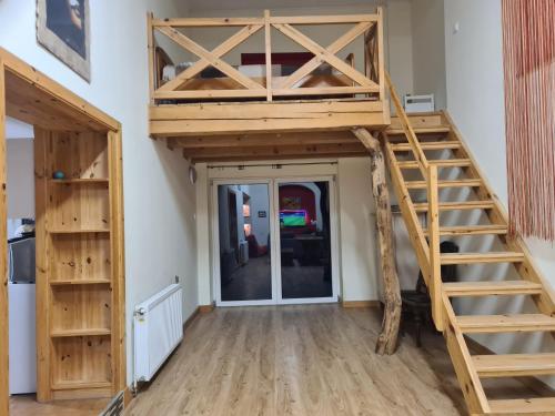 a loft bed in a room with a staircase at Dom z Klimatem in Wałbrzych