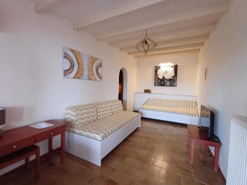 a living room with a couch and a table at Penelope Apartment Hotel in Dassia