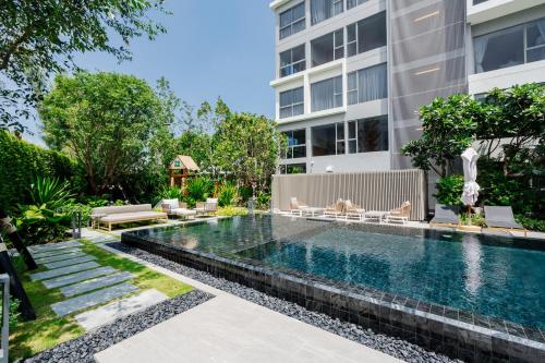 an image of a swimming pool in front of a building at Laguna Lakeside apartments with panoramic view in Bang Tao Beach
