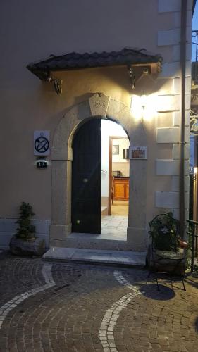 an entrance to a building with a black door at Meridiana in Santa Maria del Molise