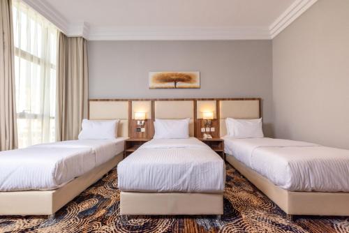 Ένα ή περισσότερα κρεβάτια σε δωμάτιο στο GH HOTEL - فندق جي اتش