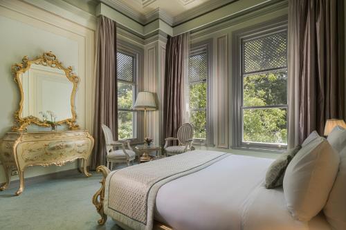 a bedroom with a bed and a mirror and a desk at Bosphorus Palace Hotel in Istanbul