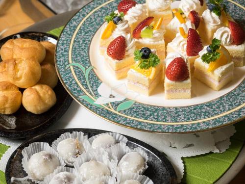 a table topped with two plates of food with desserts at Hotel Areaone Hiroshima Wing in Higashihiroshima