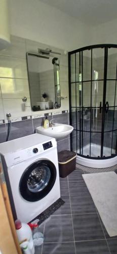 a bathroom with a washing machine and a sink at Sara&Sami in Mostar