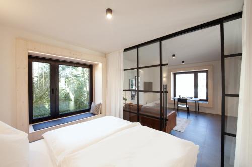a bedroom with a bed and a large window at Mono Design Apartments in Stuttgart