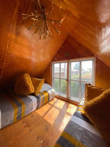 a bedroom with a bed and a large window at Cabaña BC Amecameca in Amecameca de Juárez