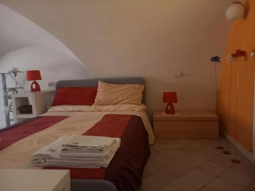 a bedroom with a bed with towels on it at Ars Amandi in Sulmona