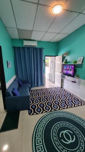 a living room with a couch and a television at MAR Homestay Seri Iskandar in Seri Iskandar