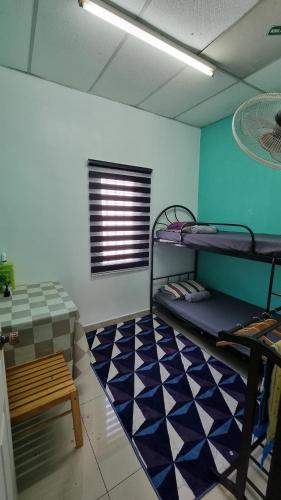a room with bunk beds and a checkered floor at MAR Homestay Seri Iskandar in Seri Iskandar