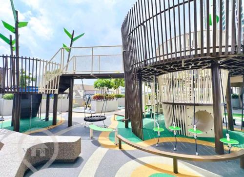 a playground with a slide and a swing at Sky Trees Apartment at Bukit Indah Johor in Johor Bahru