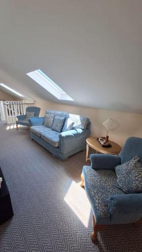a living room with two couches and a table at Ballnamona house in Cong