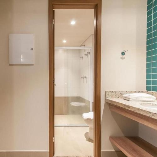 a bathroom with a shower and a toilet and a sink at Resort em Olimpia in Olímpia