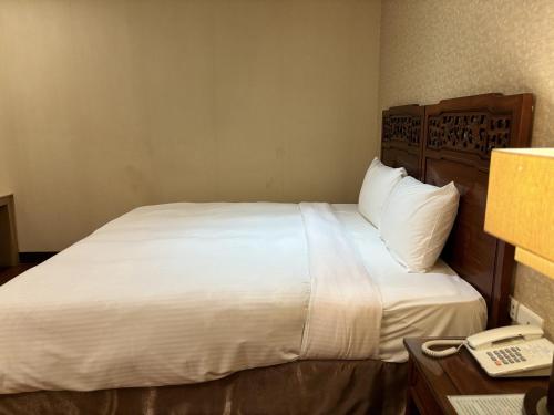 Postel nebo postele na pokoji v ubytování 花蓮凱悅旅店 Kaiyue Inn