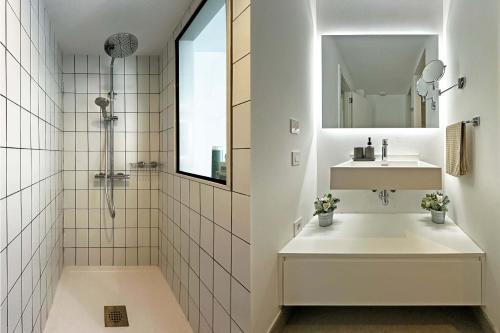 a white bathroom with a sink and a mirror at Salobre Las Yucas 5 in Salobre