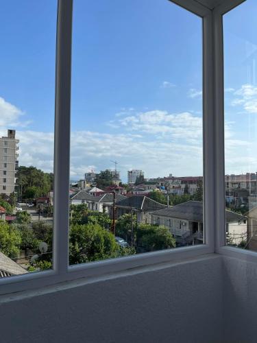 a view of a city from a window at Nino's cozy apartment in K'obulet'i