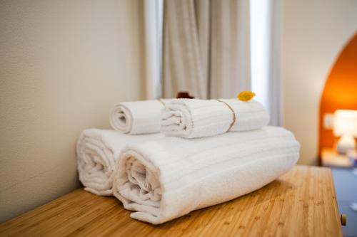 a pile of towels sitting on top of a table at Sui Tetti di Bologna centro, Casa Dei Colori in Bologna