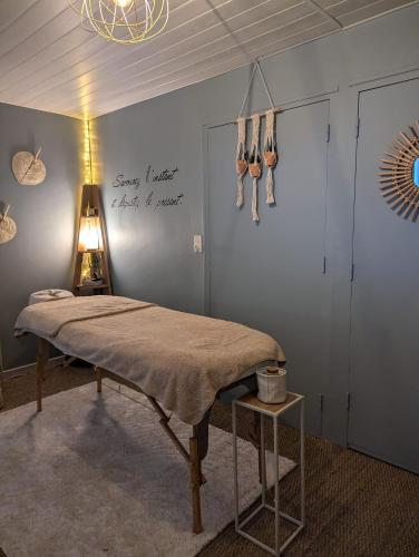 a room with a bed and a sign on the wall at Gites De La Melautais in Saint-Juvat