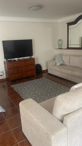 a living room with a couch and a flat screen tv at Serenity in Coto