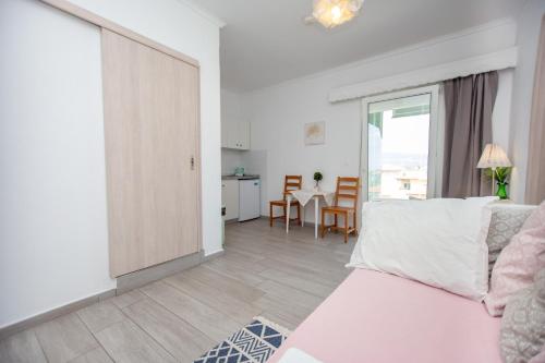 a living room with a couch and a table at T H E BERLIN Studios and Suites in Nea Vrasna