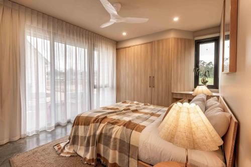 a bedroom with a bed and a large window at Birdnest Galah in Witchcliffe