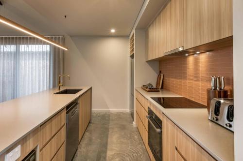 a kitchen with wooden cabinets and a counter top at Birdnest Galah in Witchcliffe