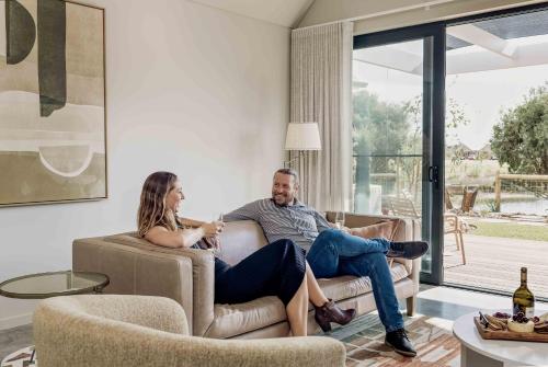 a man and woman sitting on a couch in a living room at Birdnest Galah in Witchcliffe
