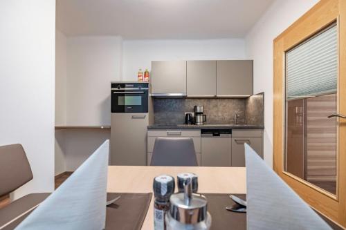 a kitchen with a table and a counter top at nawu apartments & Restaurant in Hermagor
