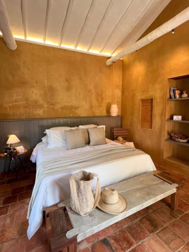 a bedroom with a large bed with a hat on a table at Terrazul Barichara in Barichara