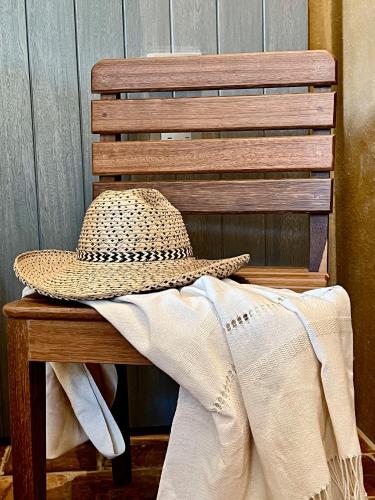 a hat sitting on top of a wooden chair at Terrazul Barichara in Barichara