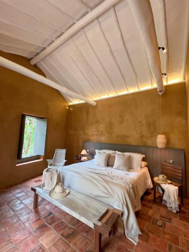 a bedroom with a large bed and a table at Terrazul Barichara in Barichara