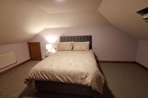 a bedroom with a large bed in a attic at Ballnamona house in Cong