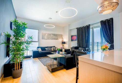 a living room with a couch and a table at Family Escape 3BR plus Maids Elegant Yas Island907W4 in Abu Dhabi