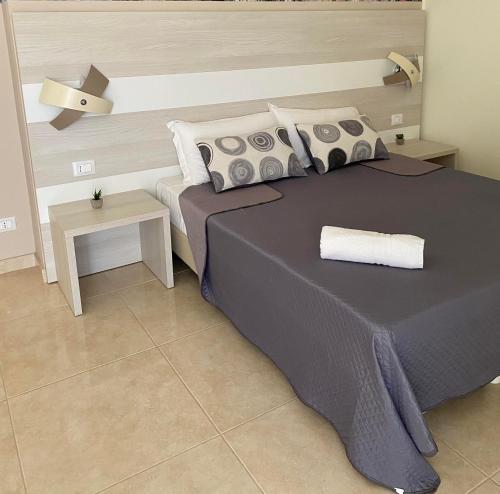 a bedroom with a large bed and a table at Regina Margherita B&B in Amantea