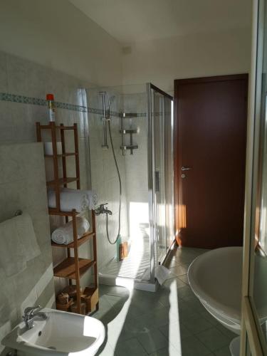 a bathroom with a shower and a sink and a tub at Appartamento con posto auto in Viareggio