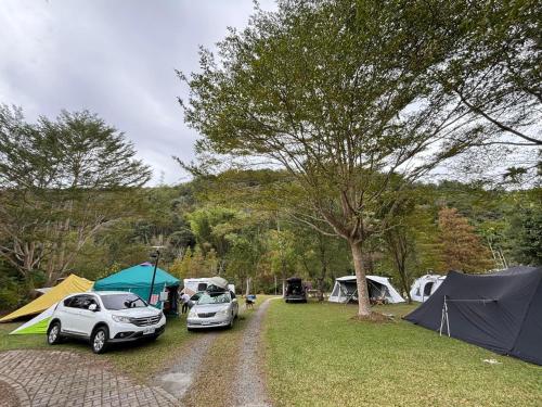 a group of tents and cars parked at a campsite at Shuizhong Yue Homestay in Guoxing