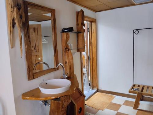 a bathroom with a sink and a mirror at Huang's Guesthouse in Chishang