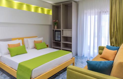 a bedroom with two beds and a couch at Maison Matie B&B Ercolano in Ercolano