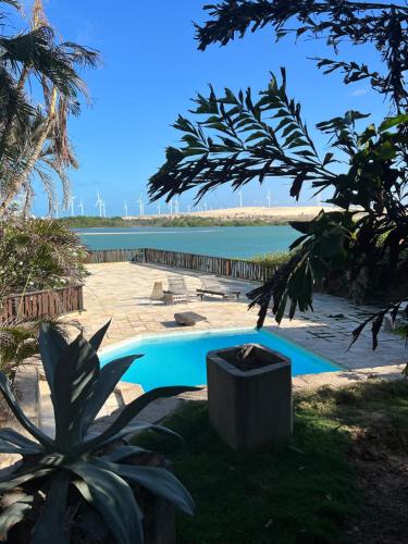 a swimming pool with a view of a body of water at Villa Jaguaribe in Fortim