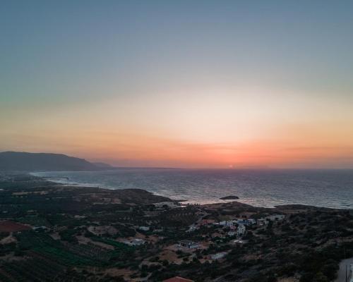 a view of the ocean at sunset at Villa Aktis with Freshwater Pool and Sea View in Sissi