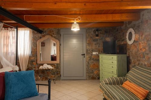 a room with a door and a chair and a mirror at Villa Aktis with Freshwater Pool and Sea View in Sissi